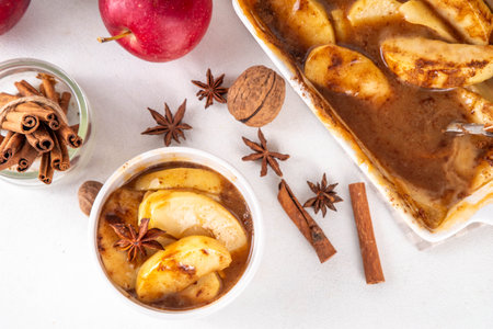 Caramel and cinnamon baked apples, paleo, vegan low-carb diet autumn dessert, apple pie trendy viral alternative, in baking pan and portionedの写真素材