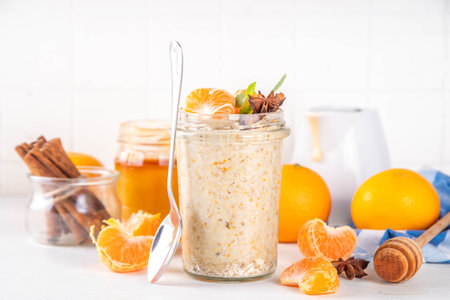 Tangerine creamsicle Overnight Oats, sweet breakfast oatmeal with creamsicle and fresh tangerine slices, spices and orange peelの写真素材