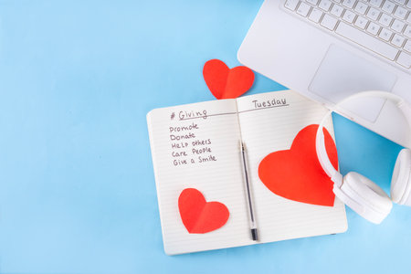 Giving Tuesday, international charity day background with red heart and text Giving Tuesday on blue...