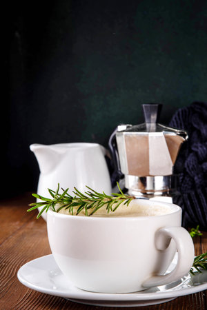 Cup of scented aromatic rosemary coffee latte, with whipped milk or creamの写真素材