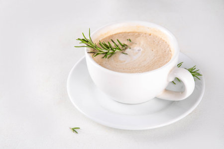 Cup of scented aromatic rosemary coffee latte, with whipped milk or creamの写真素材