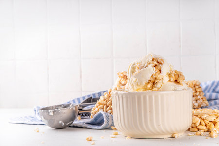 Rice krispie treats ice cream, crispy vanilla ice cream with a lot of Rice krispie Cereals, in portion bowls, on white table backgroundの写真素材
