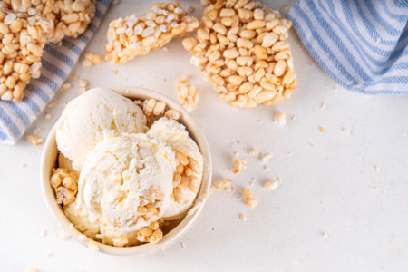 Rice krispie treats ice cream, crispy vanilla ice cream with a lot of Rice krispie Cereals, in portion bowls, on white table backgroundの写真素材
