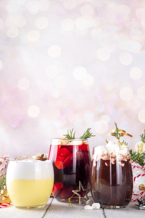 Hot drink cafes menu background, with mulled wine, eggnog and hot chocolate traditional Christmas winter cocktails and beverages, with Christmas New Year festive holiday decorations, copy spaceの写真素材