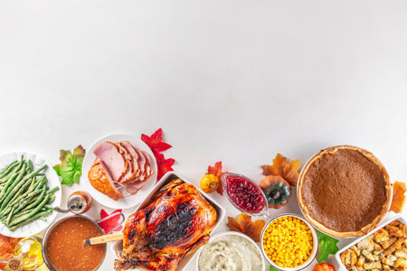 Thanksgiving dinner or lunch foods table. Assortment set of various traditional Thanksgiving holiday dishes - turkey, sides, gravy, pumpkin pie, top view copy spaceの写真素材