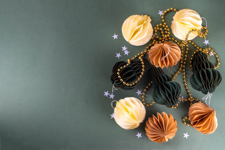 Christmas flat lay background in cozy nordic hygge style, Composition with traditional Scandinavian paper honeycomb ornaments, gift boxes, golden garland. Modern trendy eco Christmas decorの写真素材