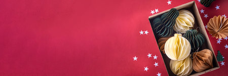 Christmas flat lay background in cozy nordic hygge style, Composition with traditional Scandinavian paper honeycomb ornaments, gift boxes, golden garland. Modern trendy eco Christmas decorの写真素材