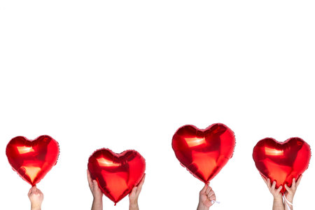 Valentine's Day holiday, February 14 background. Female male hands holding beautiful bright red heart balloon banner different variations background for greeting card, party invitation, sale flayerの写真素材