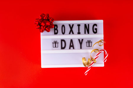 Boxing day sale seasonal promotion background with various wrapped presents gift boxes, baubles, ribbon, with inscription frame Boxing day, Christmas decor, ribbonsの写真素材