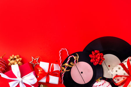 Christmas and New Year music concept. Gift for music lovers, music playlist for celebrating Xmas background. Vintage retro vinyl records for gramophone player, with Christmas decorations and gift boxesの写真素材