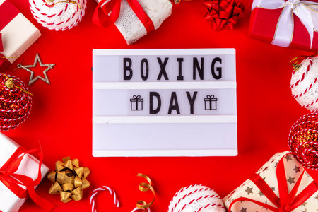 Boxing day sale seasonal promotion background with various wrapped presents gift boxes, baubles, ribbon, with inscription frame Boxing day, Christmas decor, ribbonsの写真素材