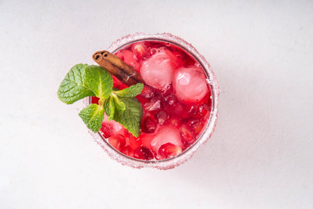 Spiced up winter berry Margarita cocktail or mocktail with orange, cranberry, pomegranate mint and crushed ice, Sweet non-alcohol or alcohol vodka drink for Christmas partyの写真素材
