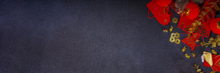 Chinese new year background, with festive red Chinese lanterns, paper fans and traditional New Year decor, stripes posters for wishes on black background top view copy spaceの写真素材