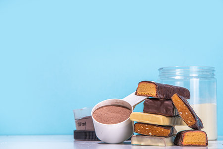 Set of various energy protein bar. Different taste of protein bars and snacks, with protein protein powder jar on high colored background copy spaceの写真素材