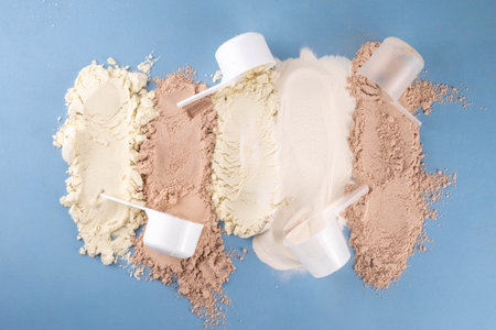 Different protein flavors in plastic scoops. Protein powder shakes for weight loss, set every day protein goals, sport and fitness, healthy lifestyleの写真素材