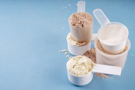 Different protein flavors in plastic scoops. Protein powder shakes for weight loss, set every day protein goals, sport and fitness, healthy lifestyleの写真素材