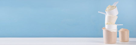 Different protein flavors in plastic scoops. Protein powder shakes for weight loss, set every day protein goals, sport and fitness, healthy lifestyleの写真素材