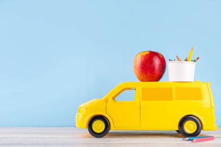 Teacher Appreciation Week background with school supplies and traditional gifts, bouquet of spring flowers with pens, pencils, notebooks, notepads, school bus toy, greeting card to teacher from childの写真素材