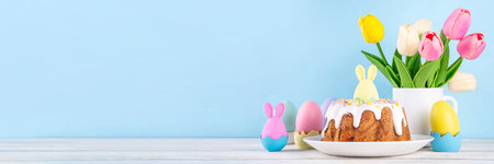 Traditional Easter cake decorated with sugar icing and sprinkles, with festive spirit decor and...