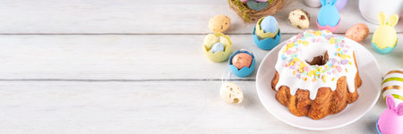 Traditional Easter cake decorated with sugar icing and sprinkles, with festive spirit decor and...
