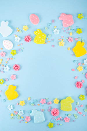 Easter sweets and candies background. High-colored blue flat lay with various Easter chocolate eggs,...