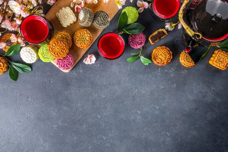 Traditional Chinese sweet dessert. Homemade Chinese snow skin and baked mooncakes, Chinese Mid-Autumn Festival food, colorful rice cakes, flatlay top view copy spaceの写真素材