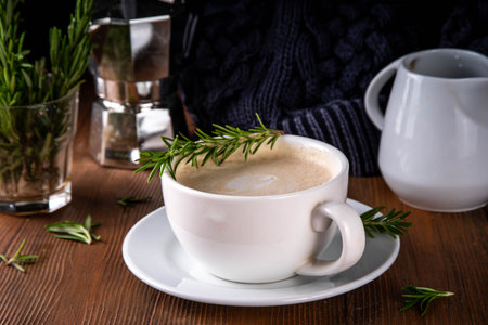 Cup of scented aromatic rosemary coffee latte, with whipped milk or creamの写真素材
