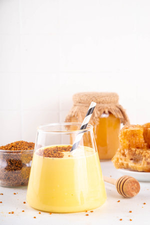 Bee pollen dish, creamy warm or cold shake smoothie golden colored drinkの写真素材