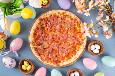 Easter dinner leftover pizza idea, delicious snack or brunch with traditional prosciutto pizza with traditional Easter ham, eggs, vegetables and cheeseの写真素材