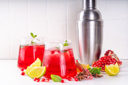 Pomegranate mocktail or cocktail, alcohol pomegranate and lime drink, lemonade, mojito, margarita with frozen rimの写真素材