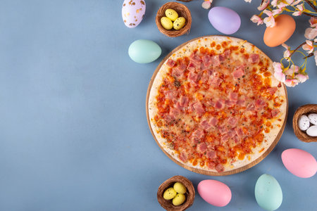 Easter dinner leftover pizza idea, delicious snack or brunch with traditional prosciutto pizza with traditional Easter ham, eggs, vegetables and cheeseの写真素材
