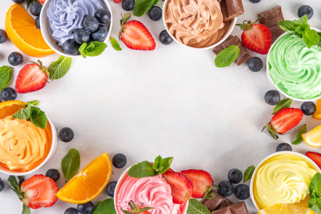 Frozen yogurt assortment. Soft creamy ice cream with chocolate, vanilla, berry, fruit flavors. Various tastes frozen yogurt cup with ingredients - blueberry, chocolate, strawberry, orange, lemon, mintの写真素材
