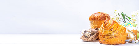 Easter background with baking cruffin pandoro pannetone cake, with colorful painted Easter eggs. Happy Easter greeting card backgroundの写真素材