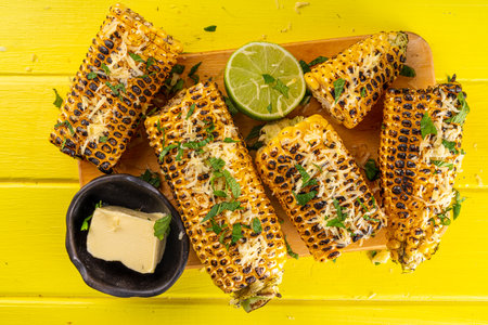 Vegan bbq food, grilled salted spicy corn with greens top view copy spaceの写真素材