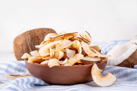 Homemade coconut chips, healthy organic coconut crackers, alternative snack for keto, diet lifestyle, with fresh coconut, copy spaceの写真素材