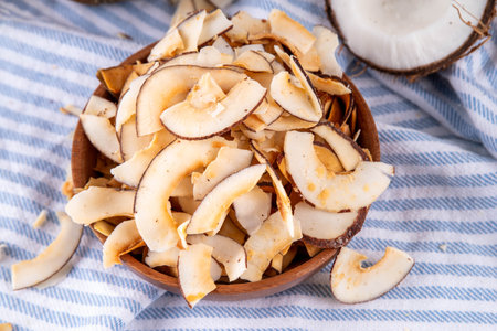 Homemade coconut chips, healthy organic coconut crackers, alternative snack for keto, diet lifestyle, with fresh coconut, copy spaceの写真素材