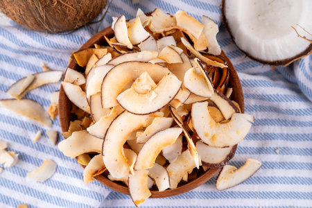 Homemade coconut chips, healthy organic coconut crackers, alternative snack for keto, diet lifestyle, with fresh coconut, copy spaceの写真素材