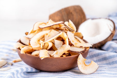 Homemade coconut chips, healthy organic coconut crackers, alternative snack for keto, diet lifestyle, with fresh coconut, copy spaceの写真素材