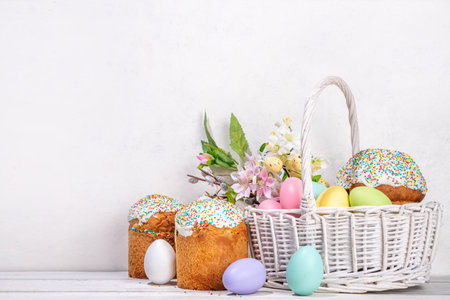 Traditional Easter basket with Easter cake, colorful pastel colored eggs, bunny rabbits decor and spring flower. Preparation for Easter celebration, greeting card, invitation, Easter sale backgroundの写真素材