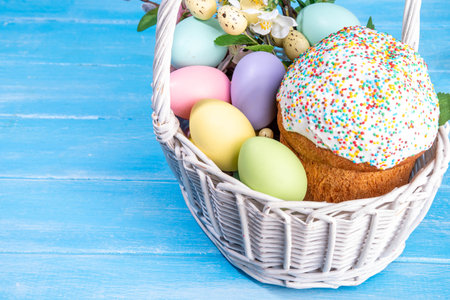 Traditional Easter basket with Easter cake, colorful pastel colored eggs, bunny rabbits decor and spring flower. Preparation for Easter celebration, greeting card, invitation backgroundの写真素材