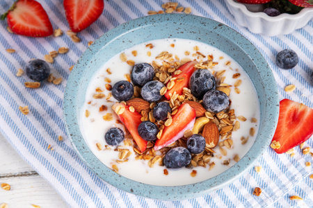 Sweet Homemade Breakfast, Greek Yogurt bowl with Granola and Berriesの写真素材