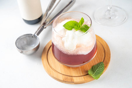 Wine Ice cream Floats cocktail, red wine cold drink with vanilla ice cream scoops, on white kitchen background, copy spaceの写真素材