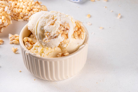 Rice krispie treats ice cream, crispy vanilla ice cream with a lot of Rice krispie Cereals, in portion bowls, on white table backgroundの写真素材