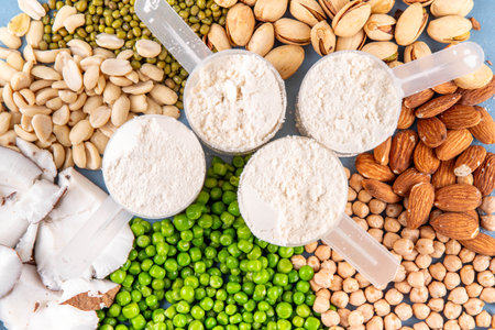 Various source vegan protein powders. Vegetarian plant based protein shakes powder and ingredient for it - green peas, soybeans, almonds, pistachios, peanuts, coconut, legumes.の写真素材