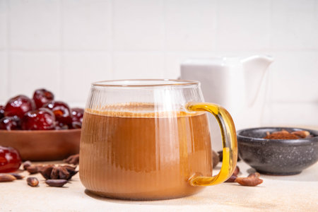 Healthy organic date seed coffee, coffee latte  cup, made with grated date seeds, with whole date fruits and seeds on beige background . Alternative coffee hot drinkの写真素材