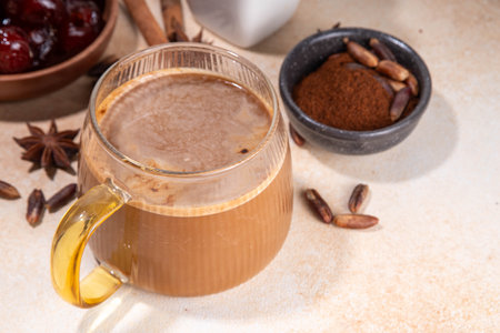 Healthy organic date seed coffee, coffee latte  cup, made with grated date seeds, with whole date fruits and seeds on beige background . Alternative coffee hot drinkの写真素材