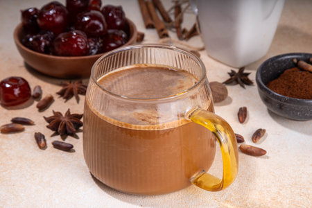 Healthy organic date seed coffee, coffee latte  cup, made with grated date seeds, with whole date fruits and seeds on beige background . Alternative coffee hot drinkの写真素材