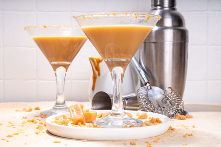 Salted caramel creamy martini drink. Sweet and salty caramel cocktail, with toffee candies, copy spaceの写真素材