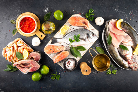 Variety raw fish and seafood background. Fresh fish, shrimps, mussels, caviar assortment flat lay, fish sale and market template,の写真素材