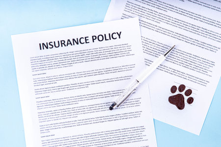 Pet health life Insurance, medical coverage concept. Insurance contract with cat paw signature and cute striped tabby cat. Flat lay mock-up for cats and dogs for insurance agency, medical servicesの写真素材